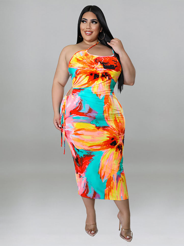 Plus-size woman wearing a colorful floral print halter neck bodycon midi dress with cut-out details and a tie waist, front view