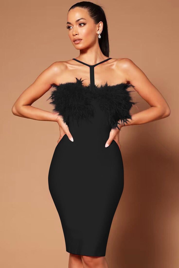 Woman wearing a black bandage dress with feather trim and halter neckline