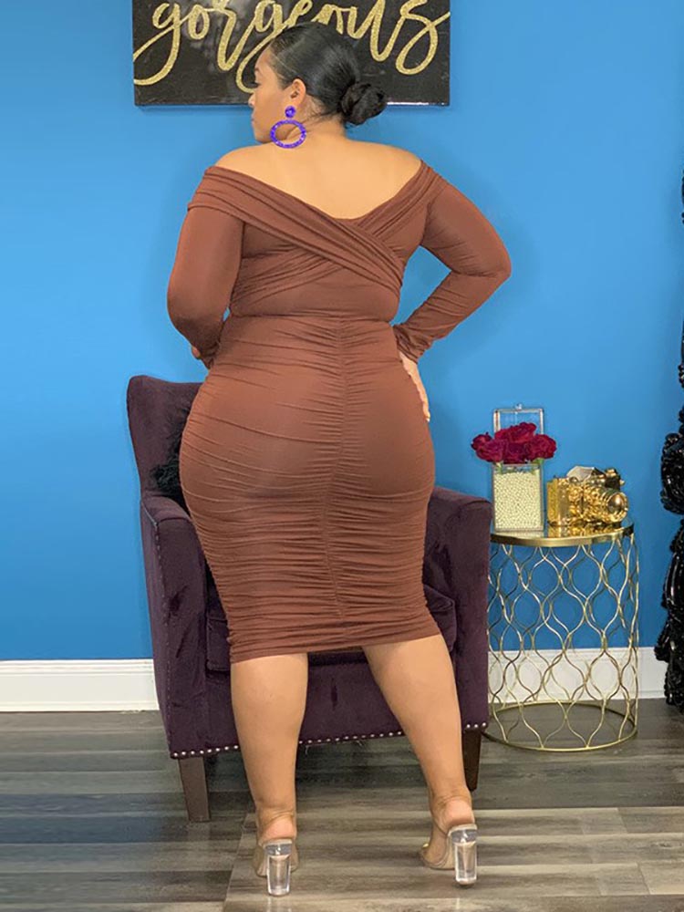 Back view of a woman in a brown ruched dress