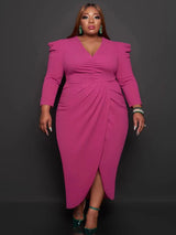 Woman wearing a fuchsia ruched V-neck sheath dress with an asymmetrical tulip hem and puffed shoulders.