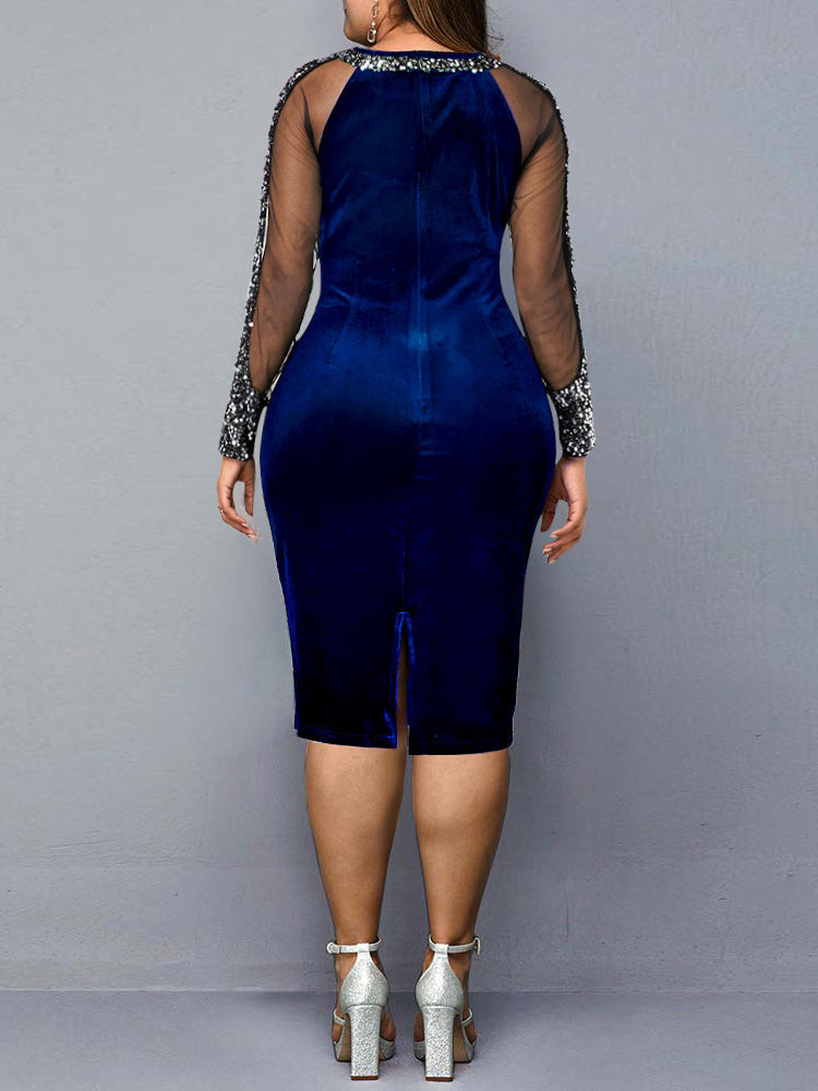 Back view of a woman wearing a blue velvet sheath dress with sequined mesh sleeves.