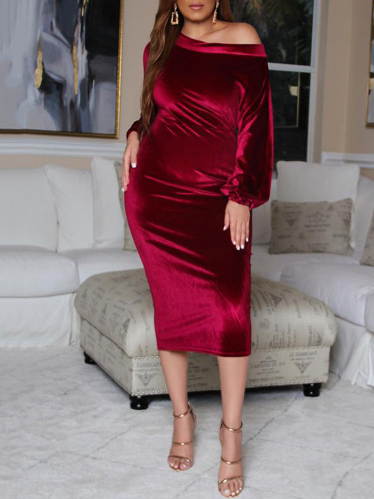 Woman from the side wearing a burgundy velvet off-the-shoulder midi dress with long sleeves.