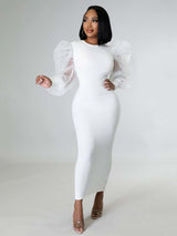 Woman wearing a white midi dress with sheer puff sleeves