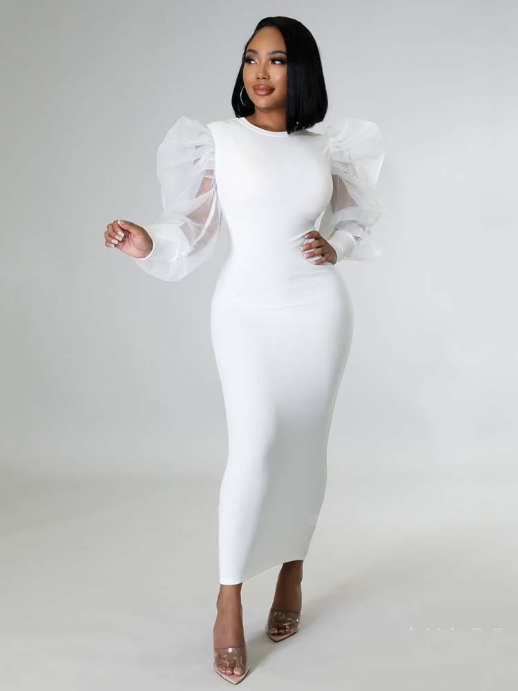Woman wearing a white midi dress with sheer puff sleeves