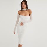 Woman wearing a white sheer long-sleeve midi dress with a corset bodice and choker neckline, standing against a white background.