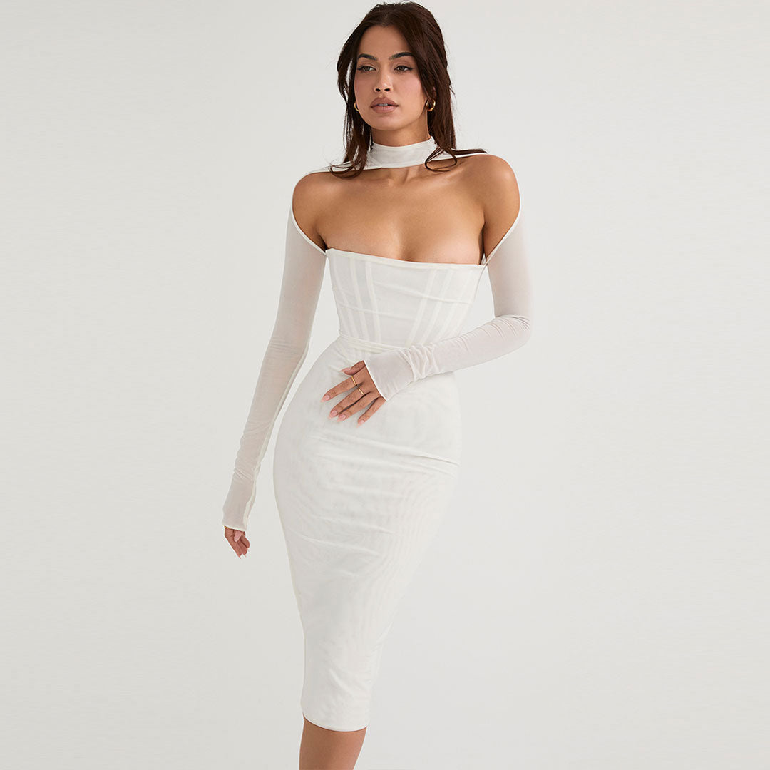 Woman wearing a white sheer long-sleeve midi dress with a corset bodice and choker neckline, standing against a white background.