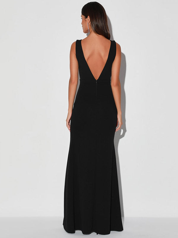 Back view of a woman in a black maxi dress with a deep V-back.