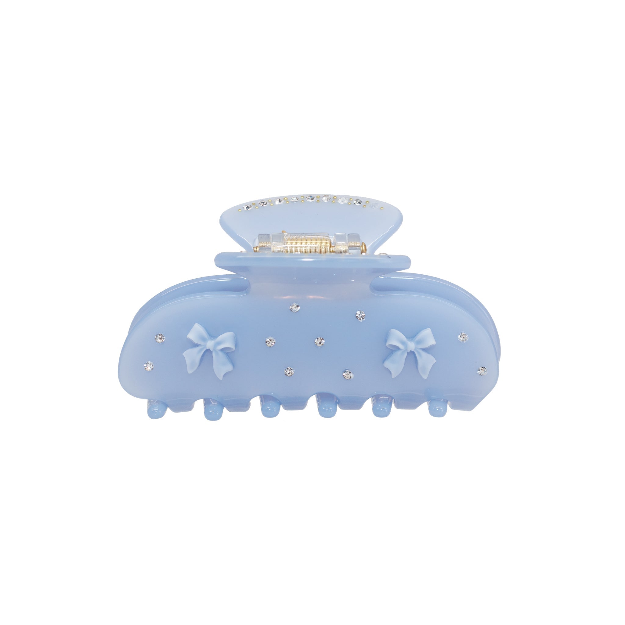 Light blue acetate claw clip with two light blue bow embellishments and scattered clear rhinestones.