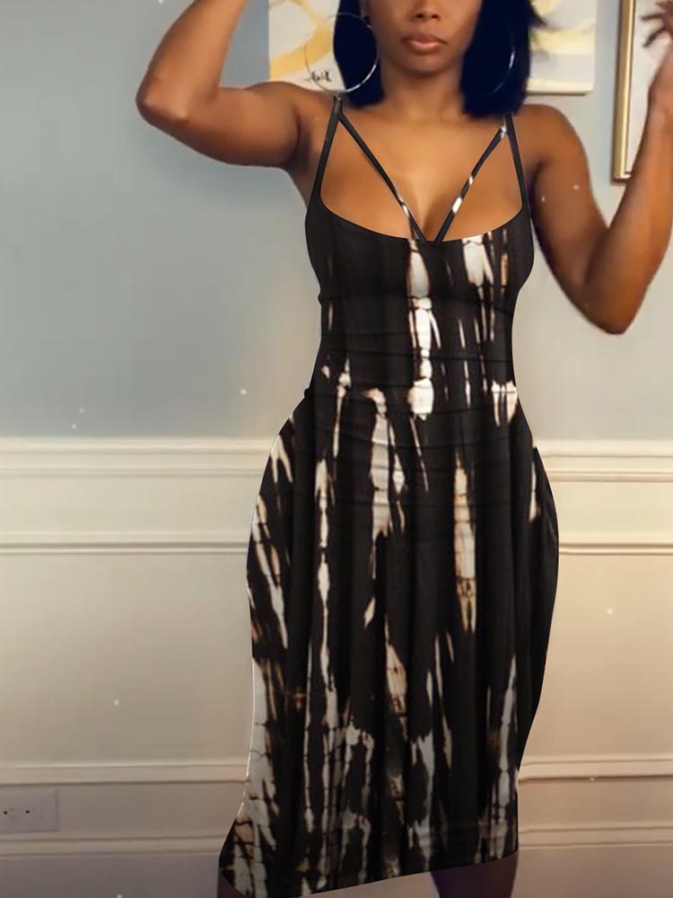Woman wearing a black and white tie-dye midi dress with spaghetti straps.