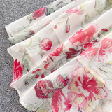 A detail shot of the layered hem of the floral print chiffon dress.