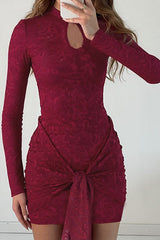 Full shot of a maroon lace mini dress with a keyhole neckline and a tie detail, displayed on a mannequin.