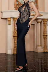 Back view of a woman wearing a black and tan lace halter neck maxi dress.