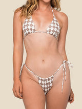 Woman wearing a brown and white gingham bikini from the front