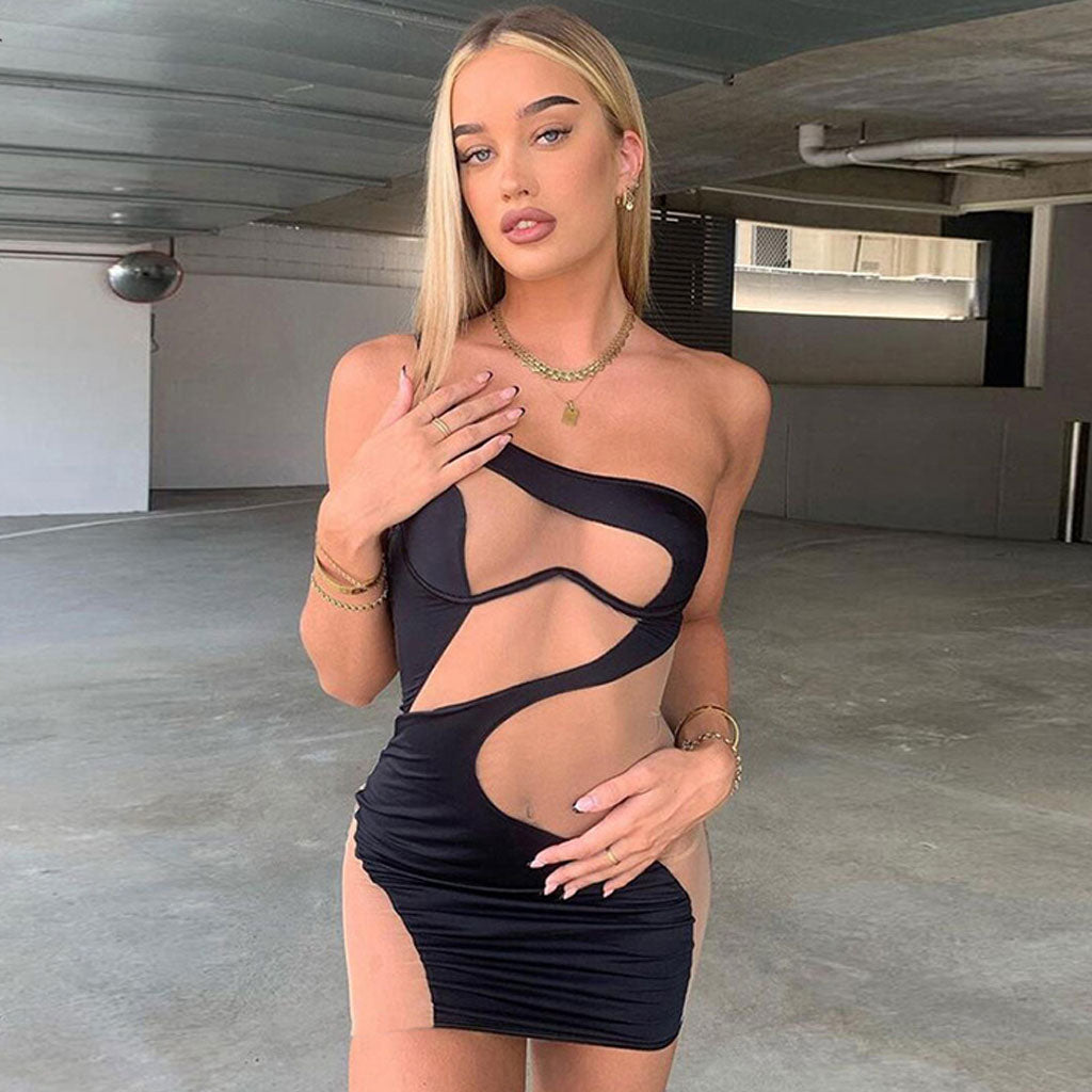 woman in black and nude asymmetrical mini dress with cut-out details
