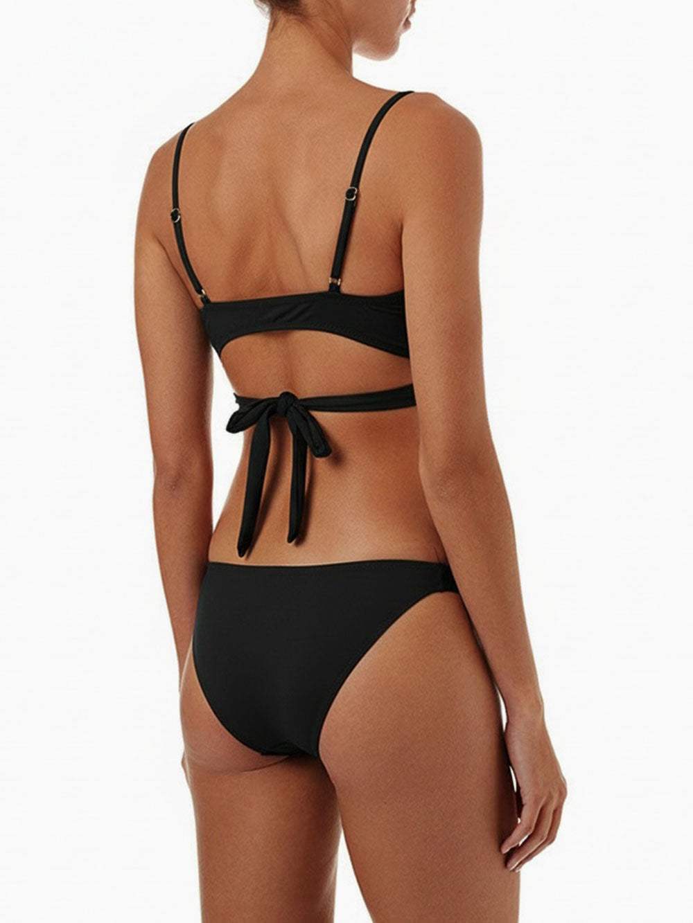 Back view of a woman wearing a black bikini with a crisscross halter top and double strap bottoms