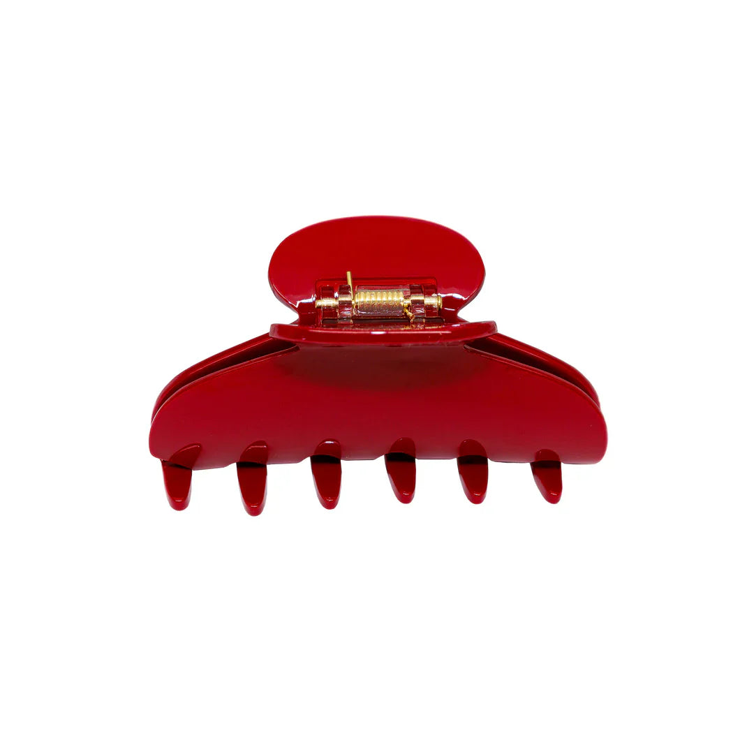 Red plastic claw hair clip with a metal spring mechanism