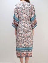 Back view of a woman wearing a long, floral print kimono.