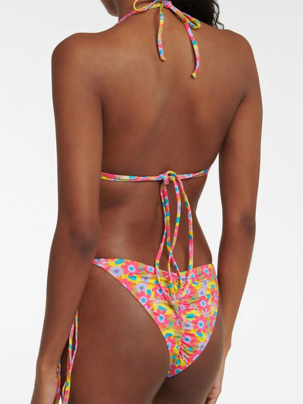 woman wearing a pink and yellow floral print bikini top and bottom, back view