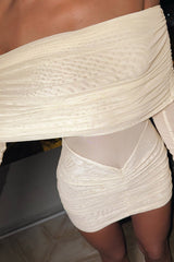 close-up of a cream off-the-shoulder ruched mini dress