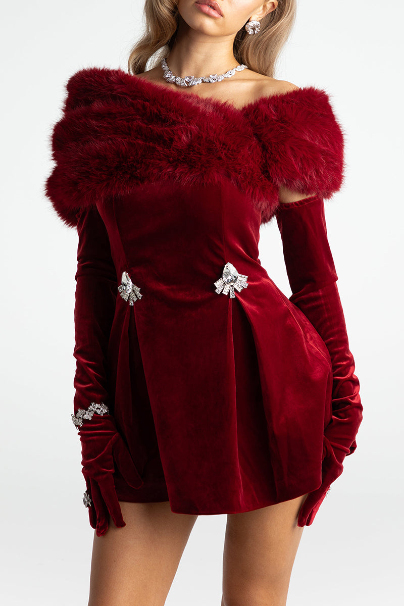 Model wearing a red velvet off-the-shoulder mini dress with feather trim and long gloves.