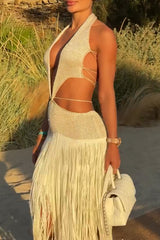 Close-up of the upper body of a woman in a white textured knit maxi dress