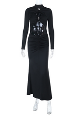 Mannequin wearing a long-sleeved black dress with cut-out details and a ruched waist
