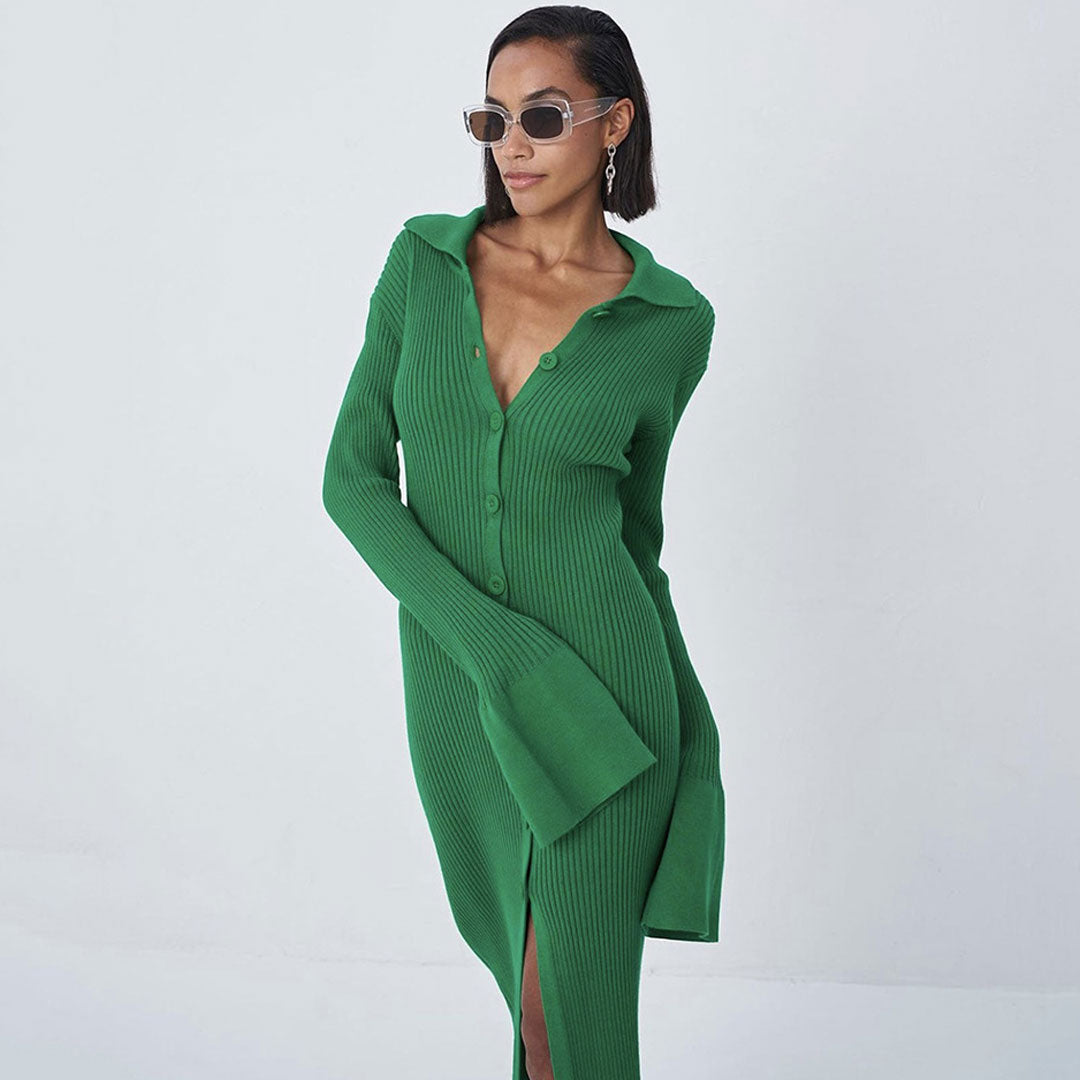 Close-up of a woman wearing a green ribbed knit midi dress with a collared neckline and bell sleeves, styled with sunglasses.