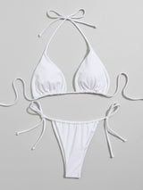 White halterneck bikini top and tie-side bottoms laid flat, front view.