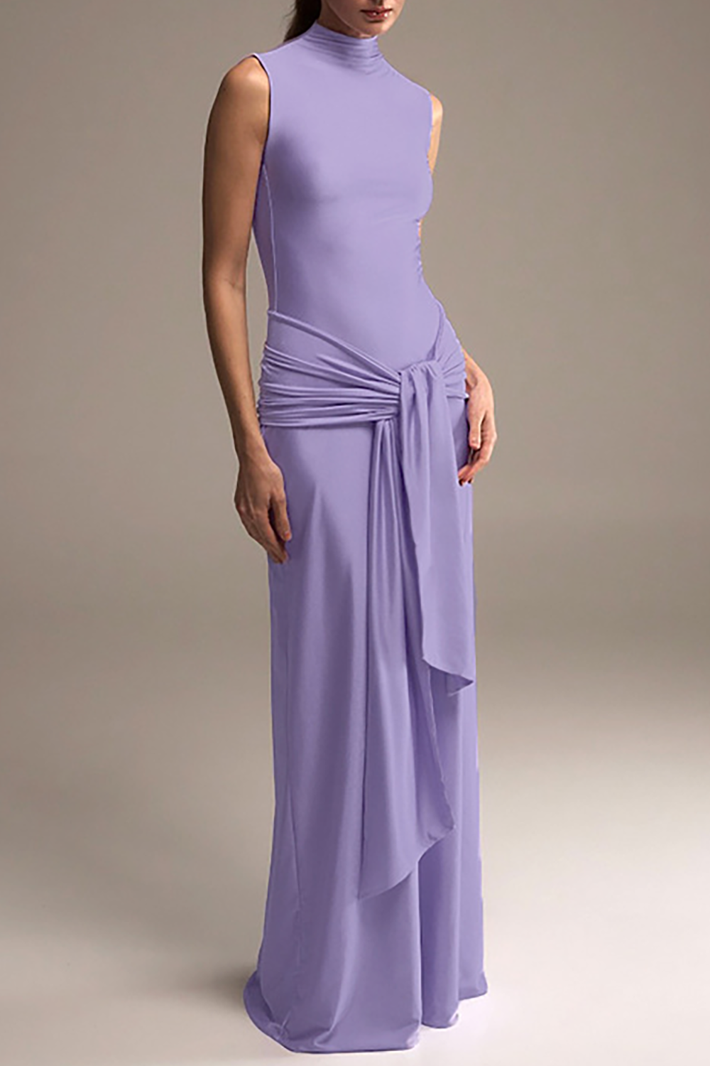 woman wearing a lavender sleeveless mock neck floor-length gown with a draped waist
