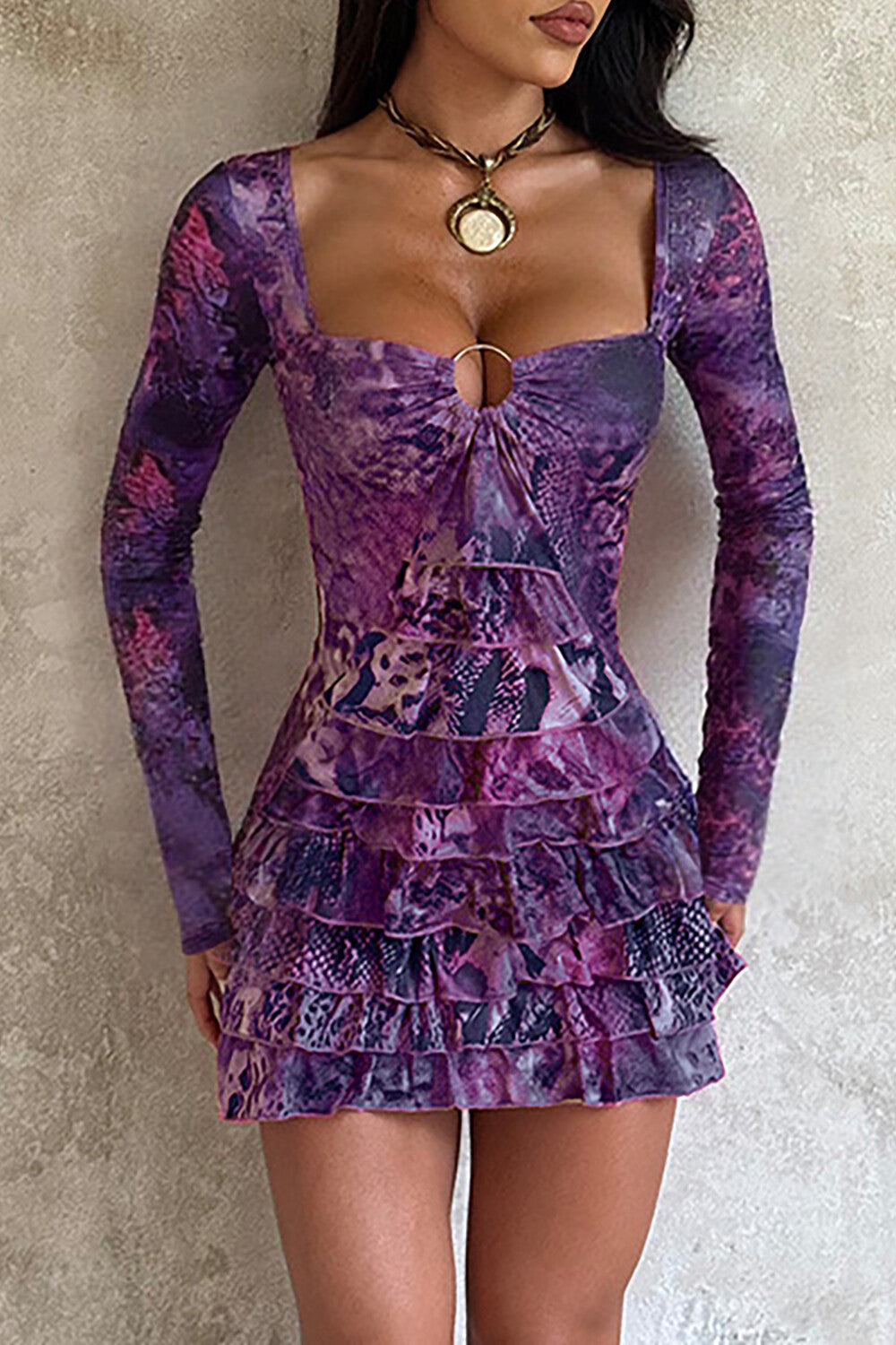 woman wearing a purple long-sleeved mini dress with a square neckline and ruffled hem