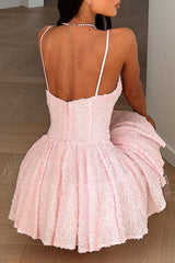 Rear view of a woman in a pink sequined dress with a zipper closure.
