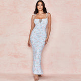 woman wearing a light blue floral print maxi dress with spaghetti straps