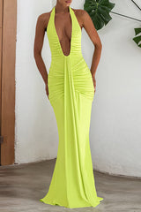 Woman wearing a neon yellow floor-length halter dress with a deep V-neckline and ruched detailing.