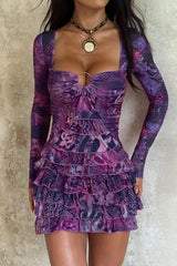 woman wearing a purple long-sleeved mini dress with a square neckline and ruffled hem