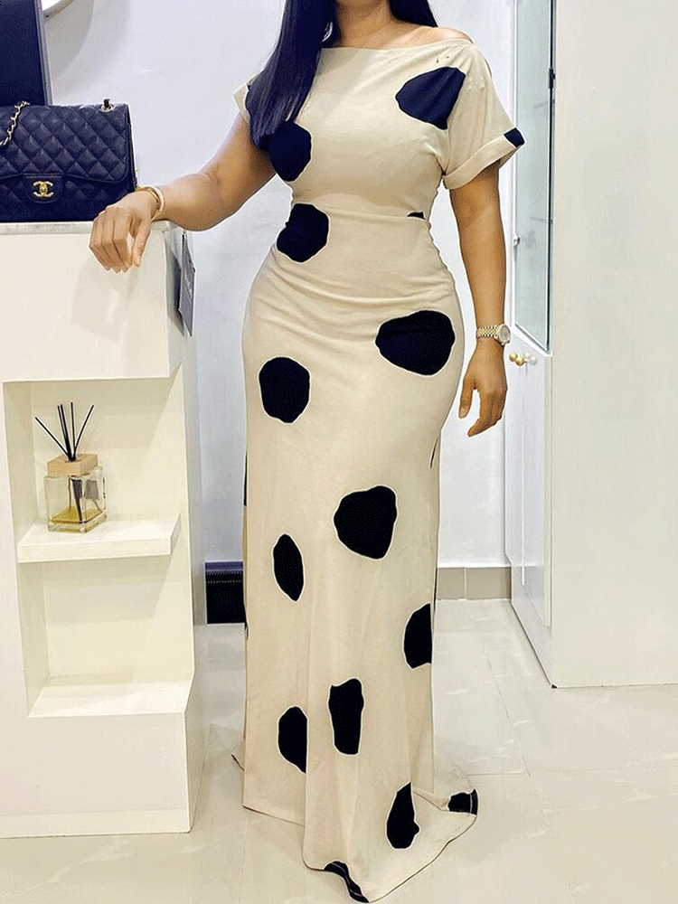woman wearing a beige maxi dress with large black polka dots