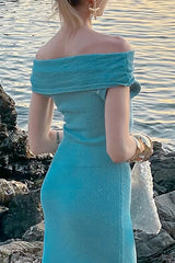 Back view of a woman in a turquoise off-the-shoulder maxi dress