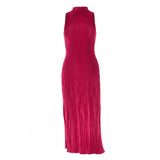 Back view of a woman in a deep pink sleeveless maxi dress with a mock neck and ribbed texture, showcasing her hairstyle