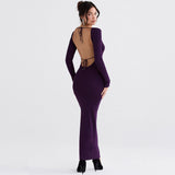 Back view of a woman in a long purple dress with an open back and tie closure.