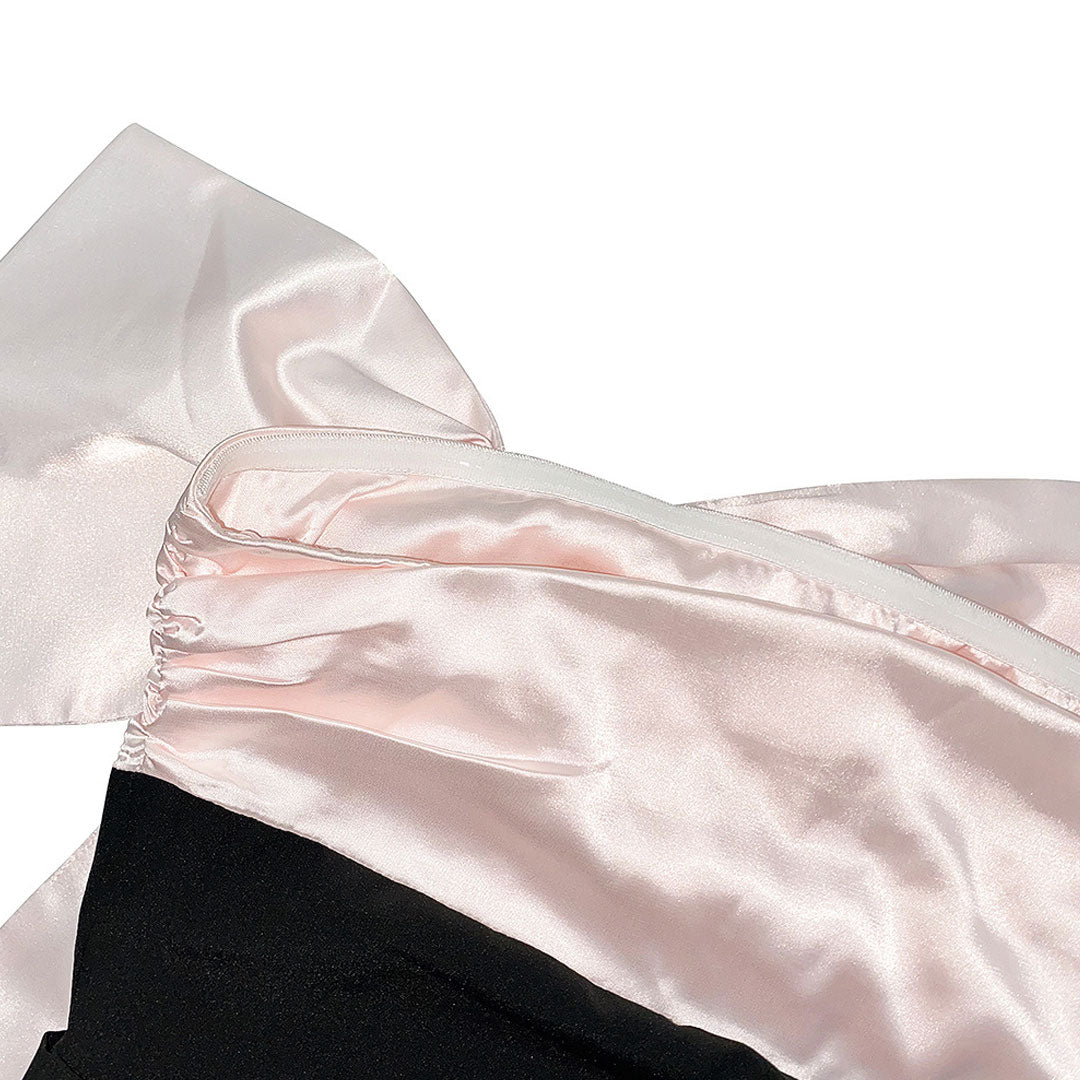 close-up detail of the satin bow and zipper on the dress
