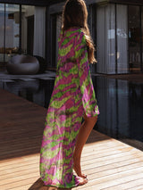 Back view of a woman in a tie-dye duster by a pool.