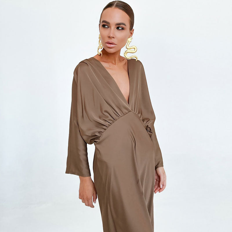 Close-up of the neckline and ruched detailing on a brown satin dress.