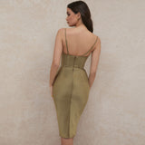 woman wearing a satin olive green midi dress with a corset bodice and spaghetti straps, back view