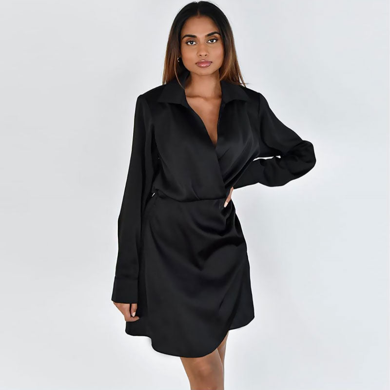 full body shot of a woman in a black satin wrap dress
