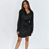 close-up of the ruched detailing on a black satin wrap dress