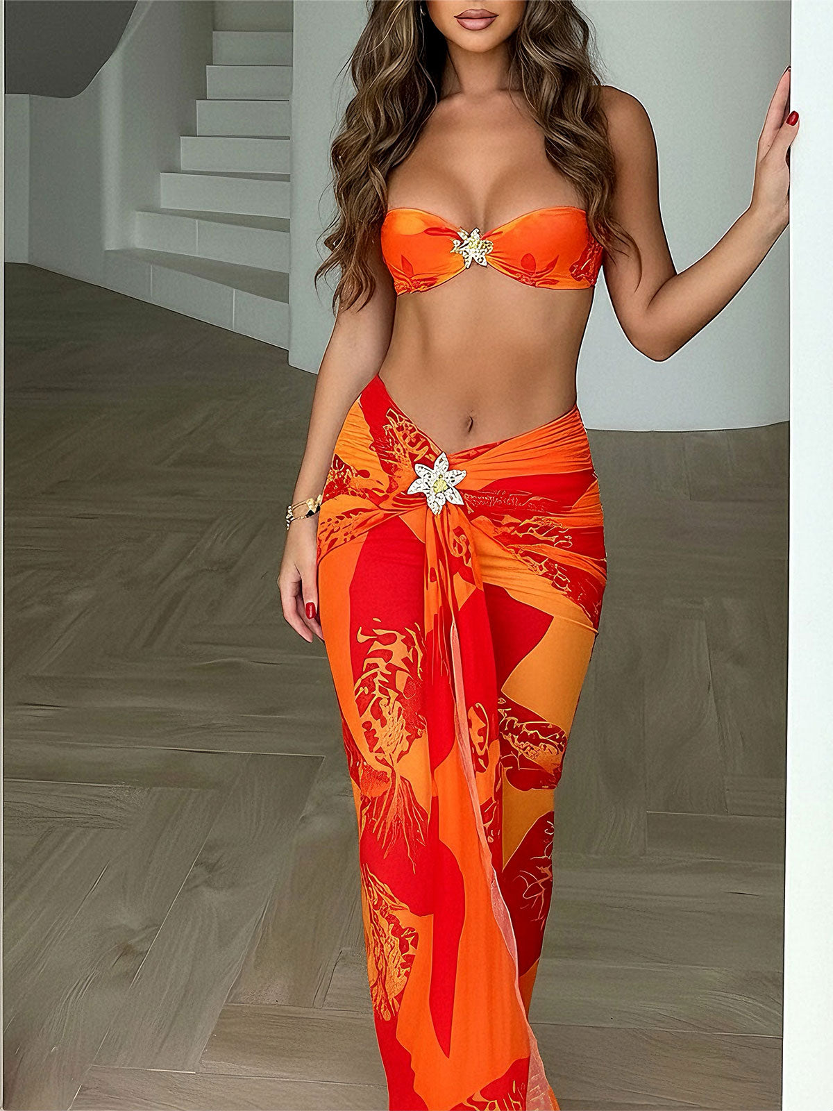 Woman wearing an orange strapless bikini top and a matching floral print sarong skirt, front view.