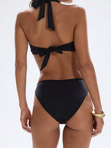 Back view of black halter neck bikini top with tie closure and matching high-cut bottoms.