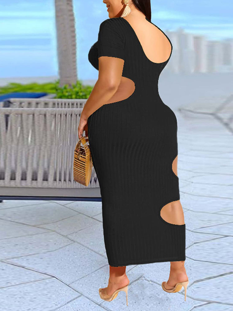 Back view of a woman in a black midi dress with cut-out details.