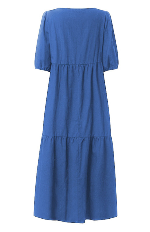 Back view of a blue tiered midi dress with puff sleeves