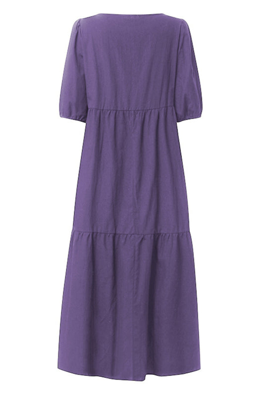 Back view of a purple tiered midi dress with puff sleeves