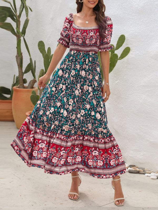 Woman wearing a floral print square-neck maxi dress with puff sleeves and a tiered skirt.